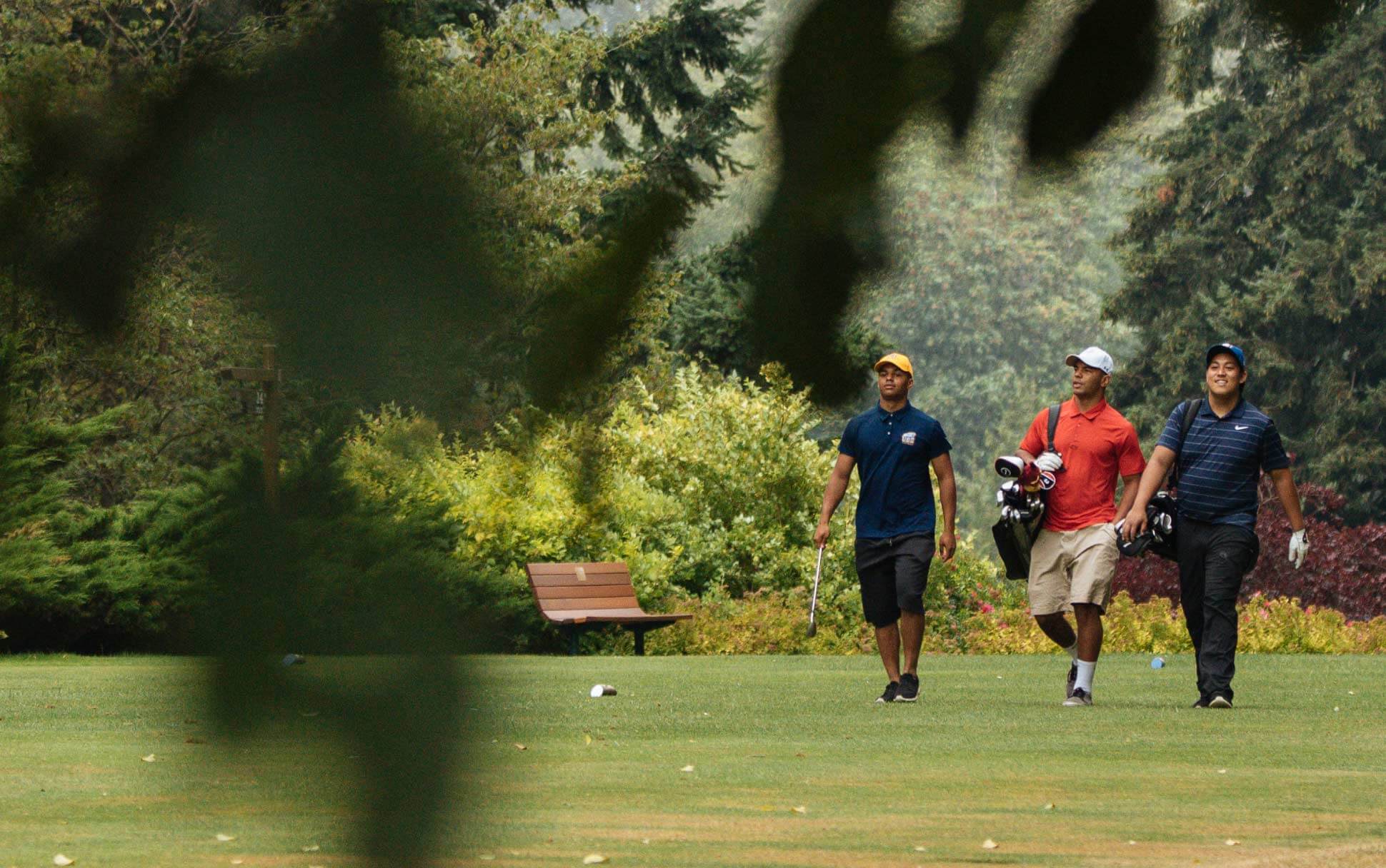 Three players walk down a fairway at the University Golf Club near UBC in Vancouver.
