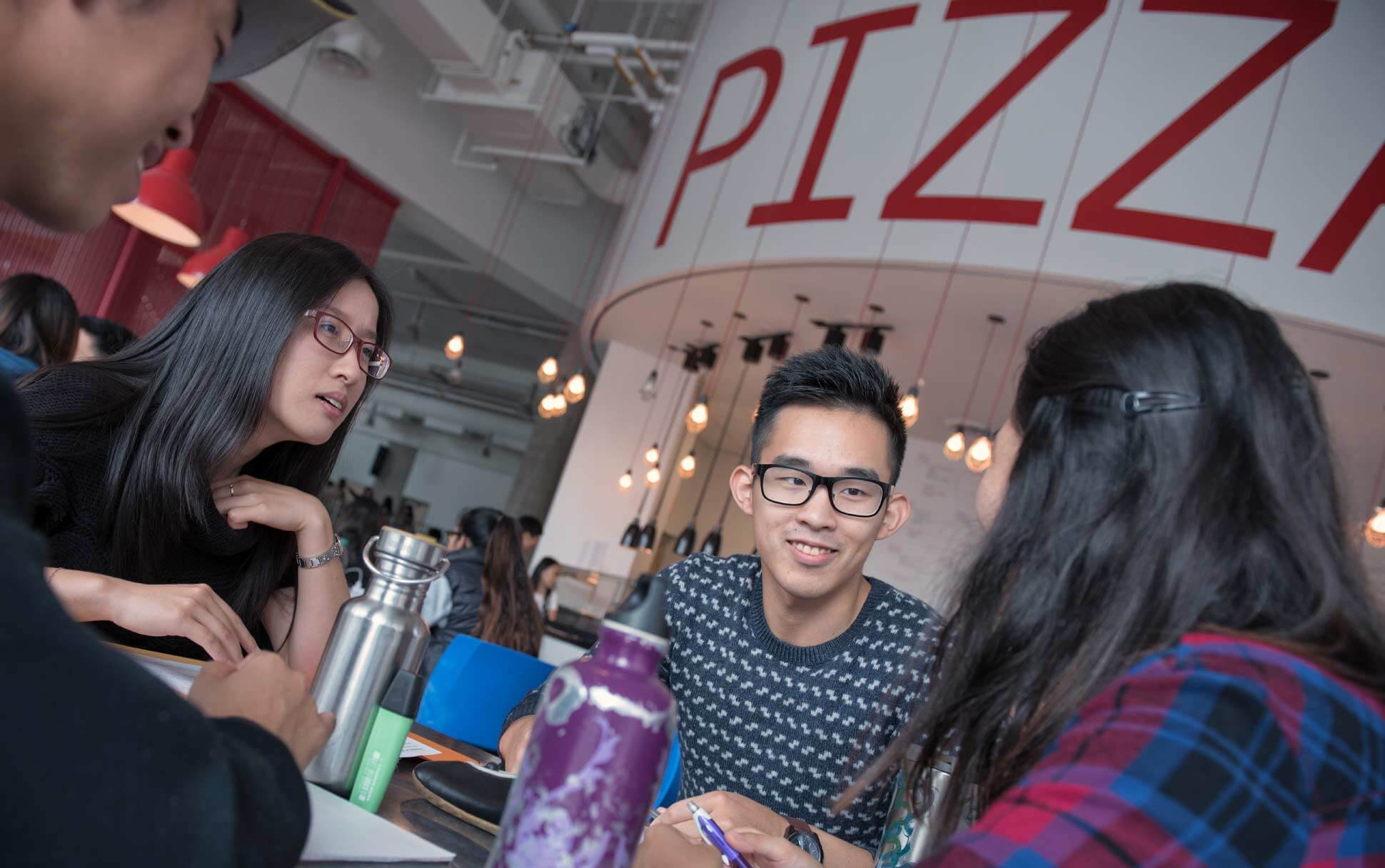 Visitors eat pizza for lunch at the AMS Student Nest food court at UBC Vancouver