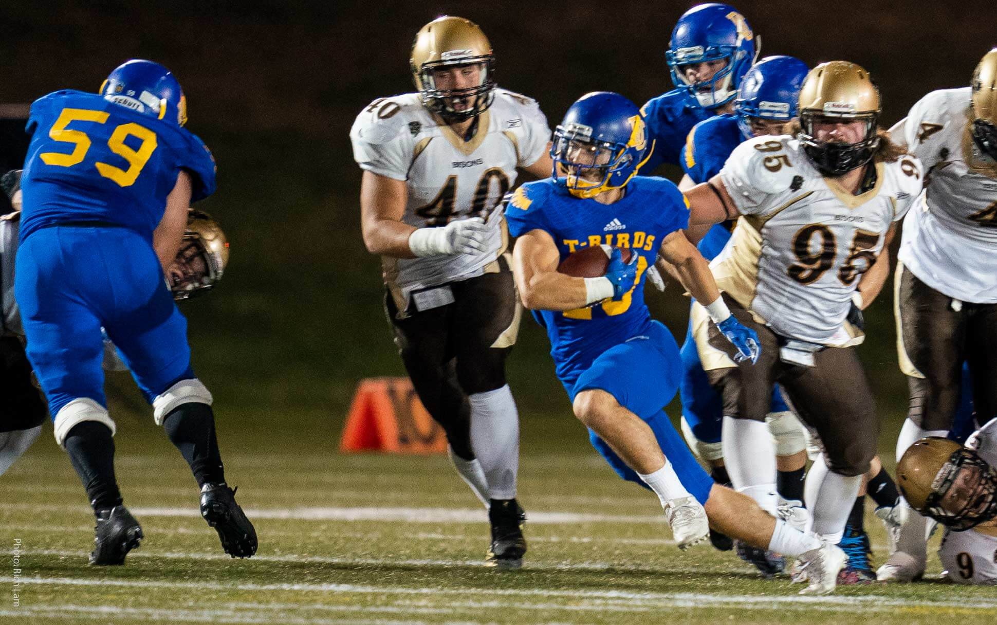 An athlete runs with a football during a UBC Thunderbirds Football game in Vancouver