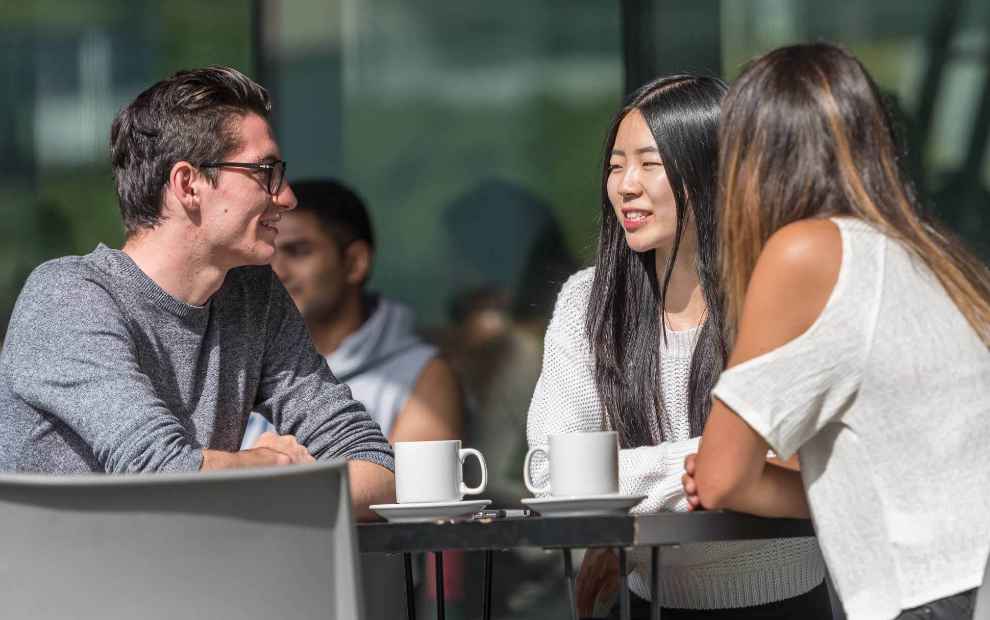 Visitors enjoy coffee at a café on UBC Vancouver's campus.