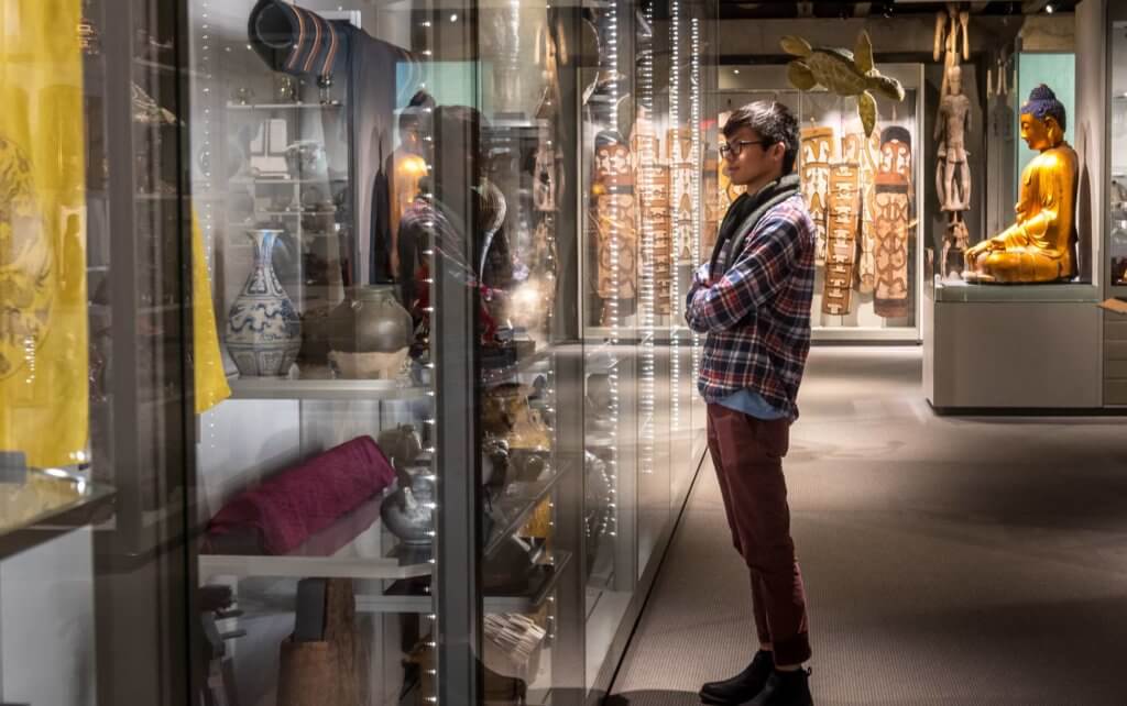 A visitor looks at artwork from Asia and Oceania at the Museum of Anthropology (MOA) at UBC Vancouver.