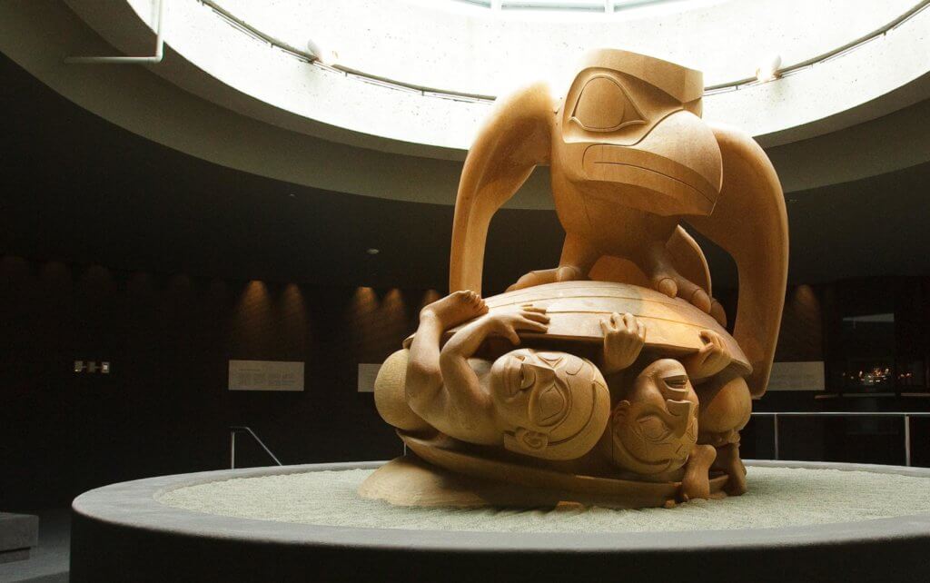 Raven and the First Man, a large, yellow cedar carving by Bill Reid, on display at the Museum of Anthropology at UBC Vancouver.